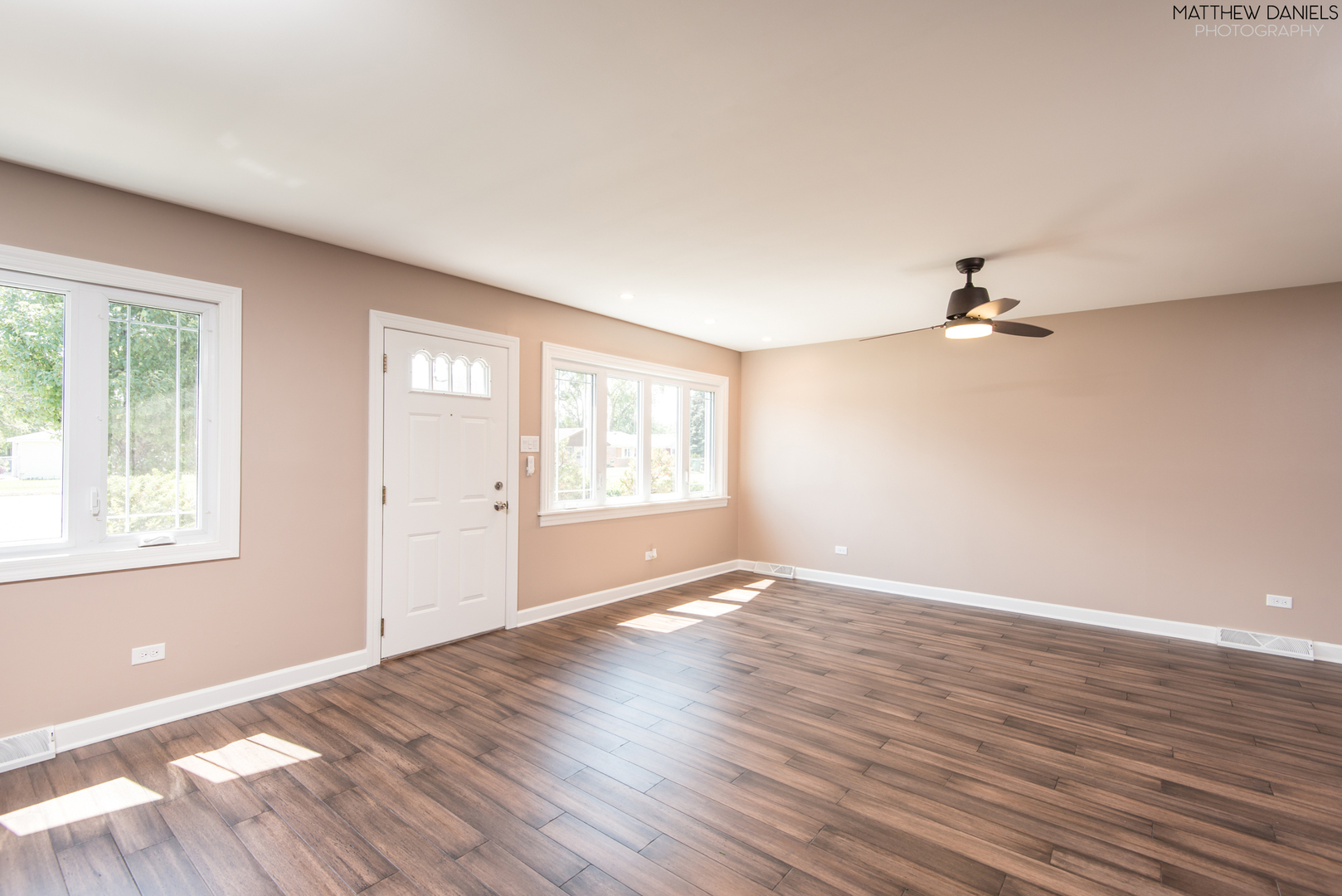 5208 State Road Burbank, IL 60459 - Photo 8 of 21 an empty room with wooden floor cabinet and windows