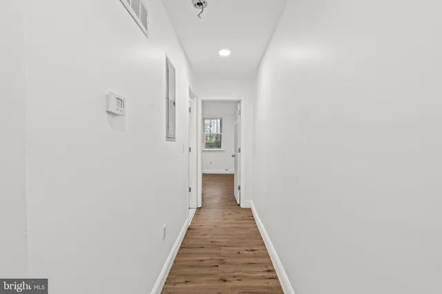 a view of a hallway with wooden floor