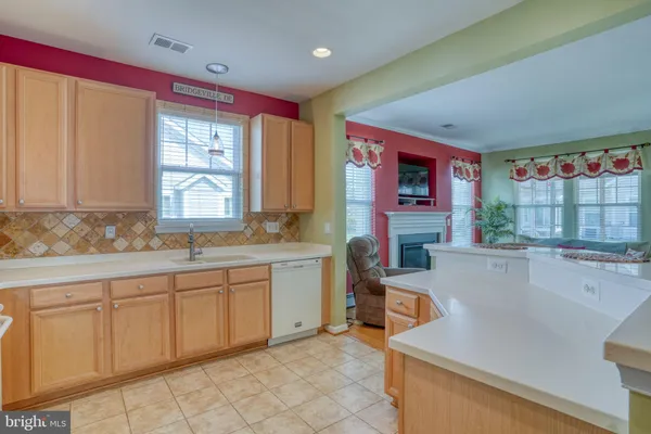 a kitchen with stainless steel appliances granite countertop a refrigerator sink and stove