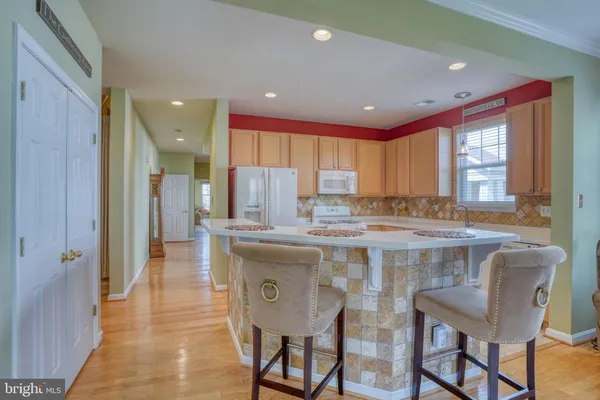 a living room with furniture and a kitchen