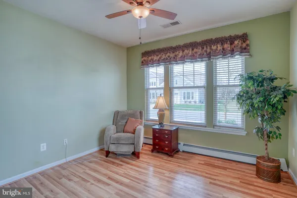 a living room with furniture a table and chair
