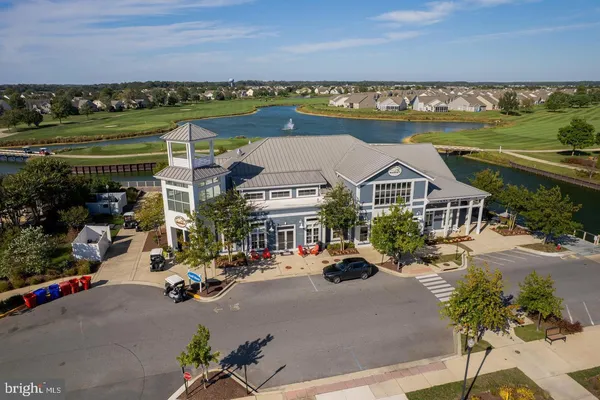 an aerial view of residential houses with outdoor space and river