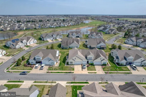 an aerial view of residential houses with outdoor space