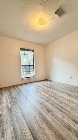 a view of a room with wooden floor
