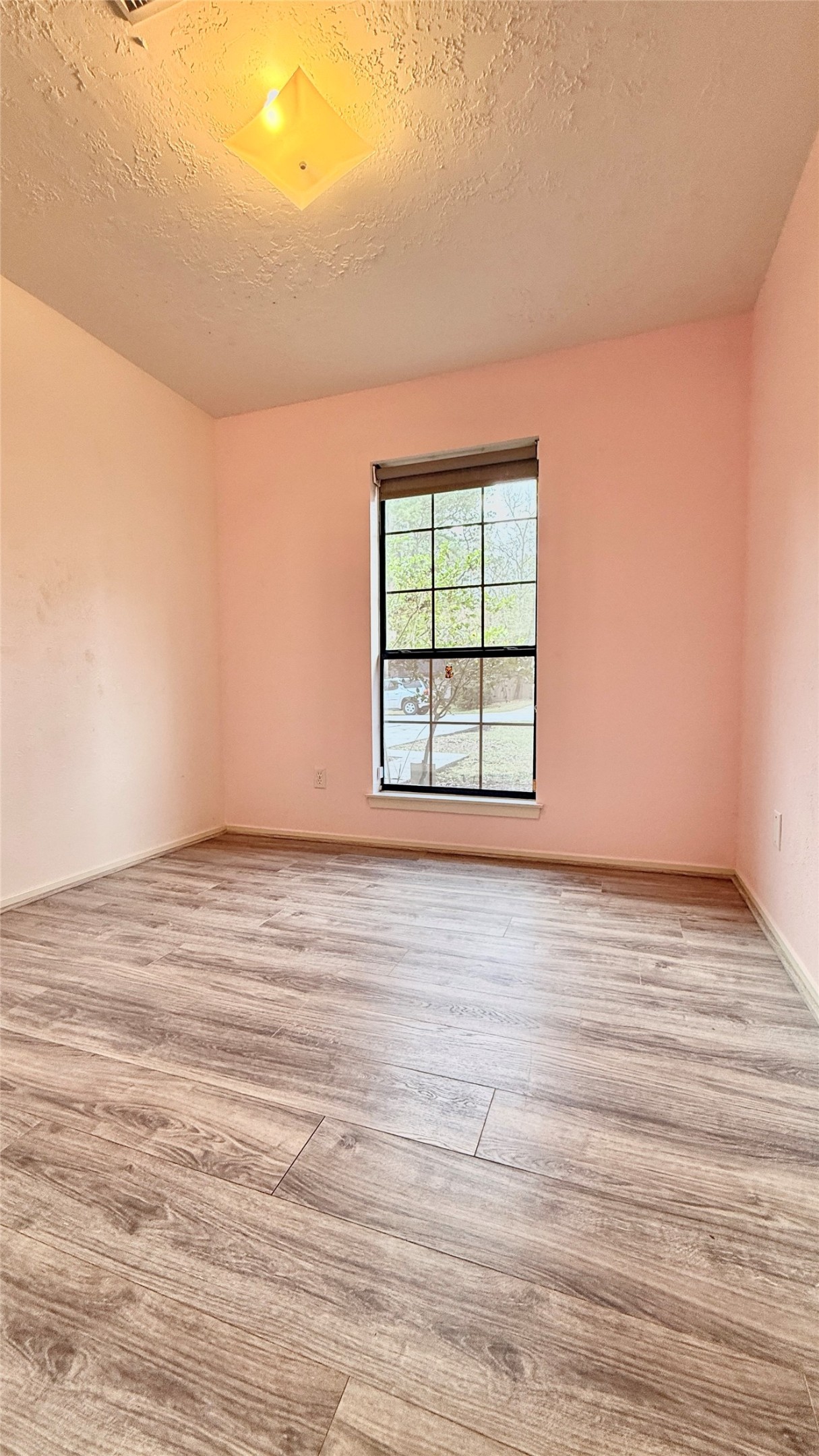 18 Dellforest Court Spring, TX 77381 - Photo 17 of 42 an empty room with wooden floor and windows