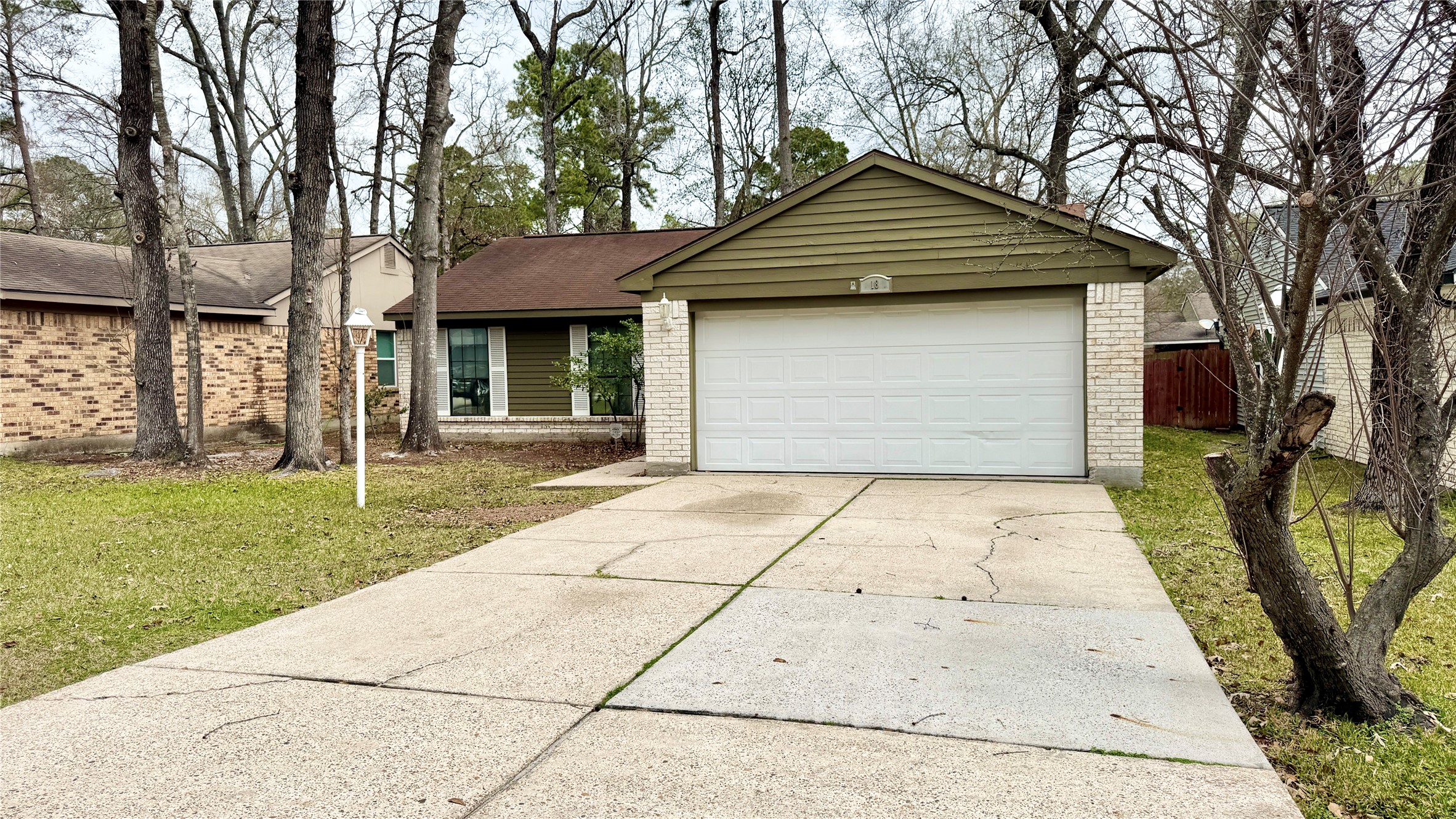 18 Dellforest Court Spring, TX 77381 - Photo 2 of 42 a front view of a house with a garden and entryway