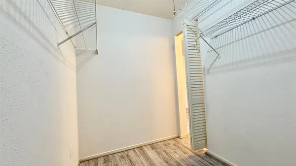 a view of a room with wooden floor