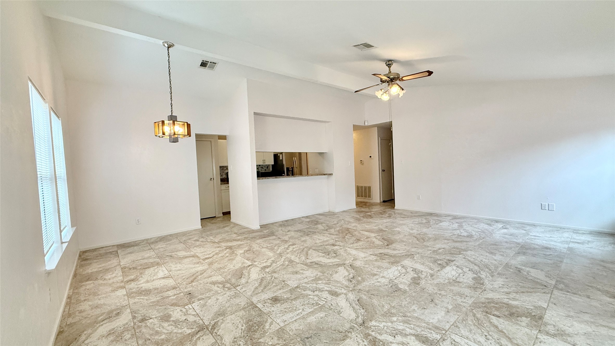 18 Dellforest Court Spring, TX 77381 - Photo 31 of 42 a view of a kitchen with a refrigerator and a ceiling fan