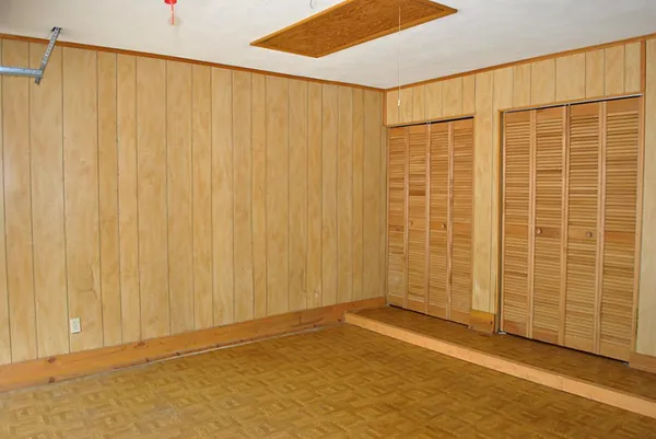 a view of a patio with table and chairs under an umbrella