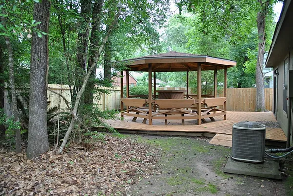 a view of backyard with green space and seating