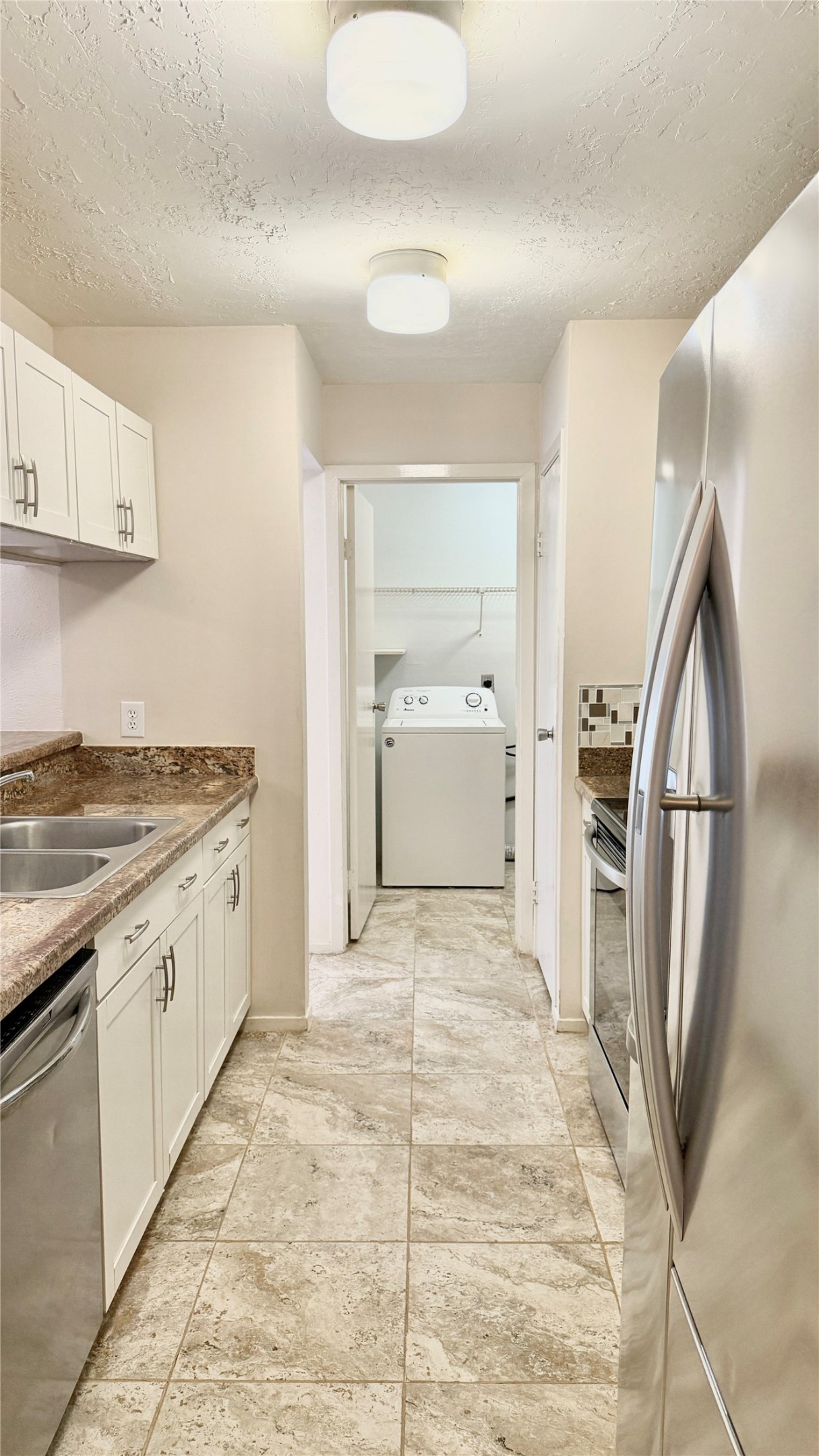 18 Dellforest Court Spring, TX 77381 - Photo 9 of 42 a large white kitchen with granite countertop a sink and dishwasher a stove top oven with wooden floor