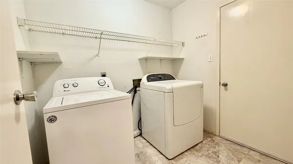 a utility room with dryer and washer