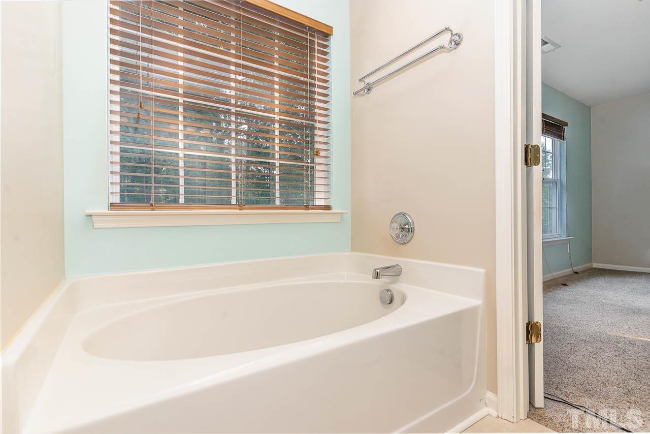 1605 October Road Raleigh, NC 27614 - Photo 27 of 31 a white bath tub sitting next to a window