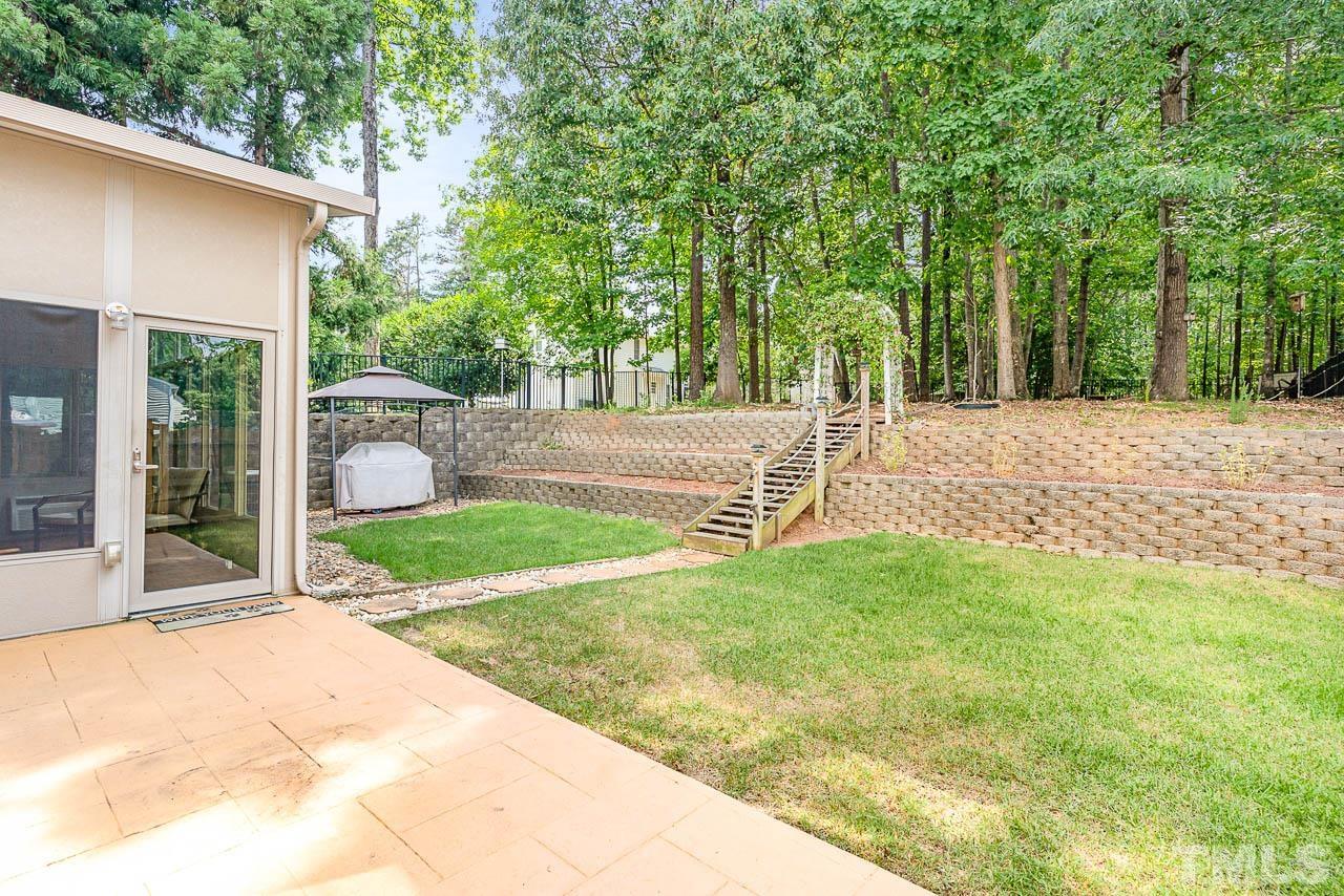 1605 October Road Raleigh, NC 27614 - Photo 9 of 31 a view of backyard with table and chairs and large trees