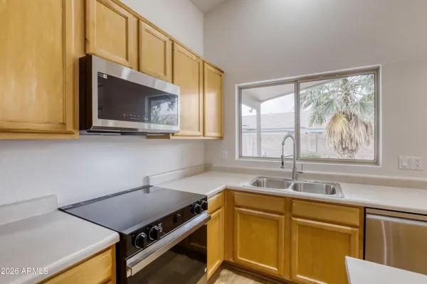 a kitchen with a stove a sink and a microwave