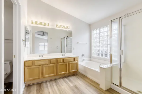 a bathroom with a tub sink and mirror