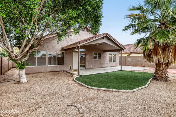 a view of a house with a backyard