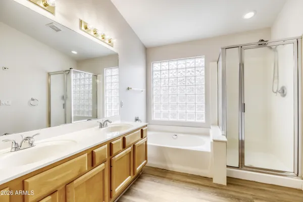 a bathroom with a granite countertop sink mirror bathtub and shower