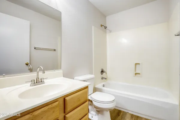 a bathroom with a sink toilet a mirror and shower
