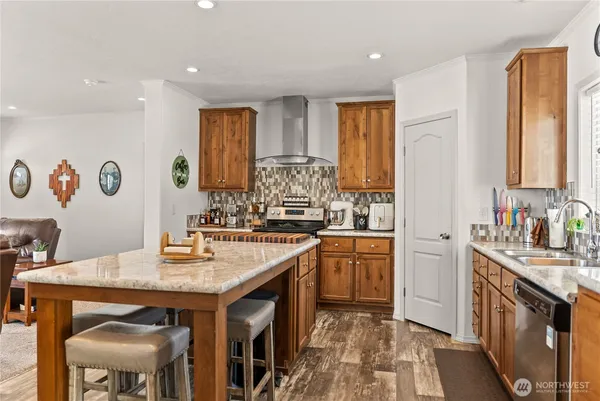 a kitchen with stainless steel appliances granite countertop a sink stove and refrigerator