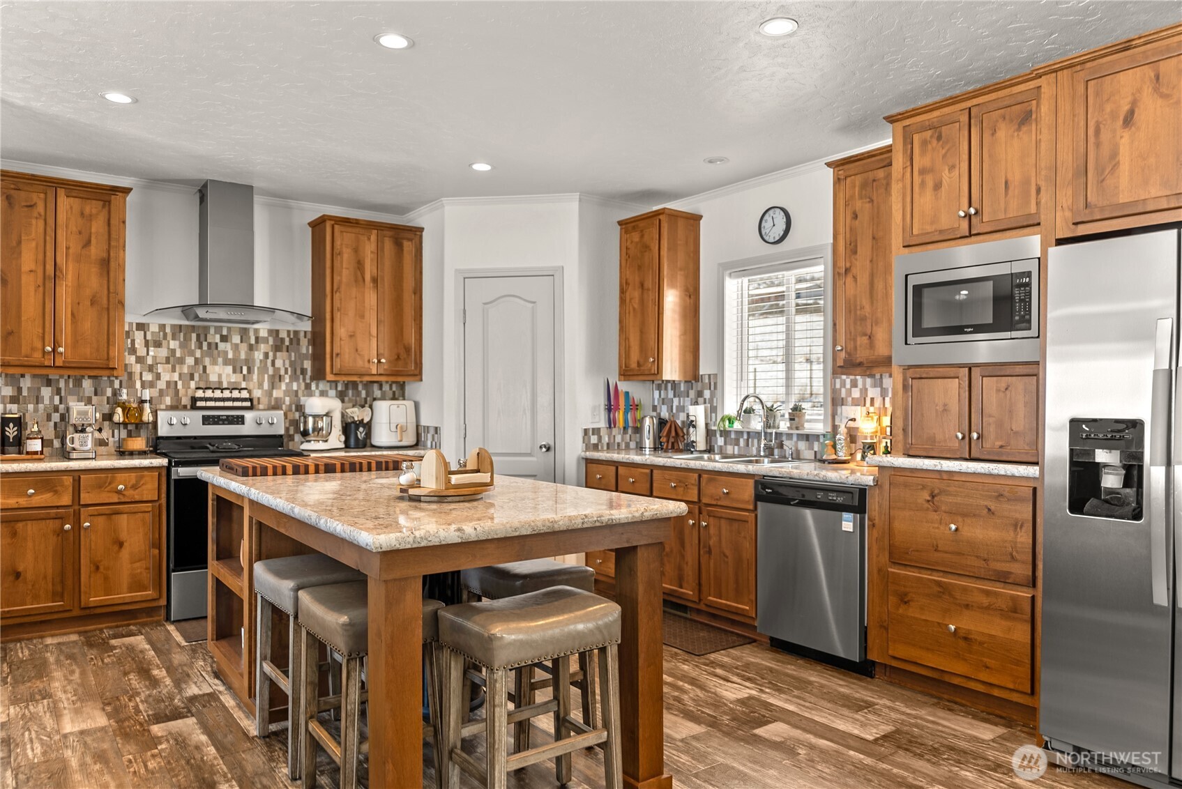 60 Alvarado Road Tonasket, WA 98855 - Photo 12 of 36 a kitchen with stainless steel appliances granite countertop a sink stove and refrigerator