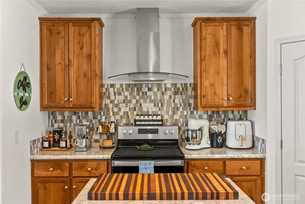 a kitchen with granite countertop a stove and cabinets
