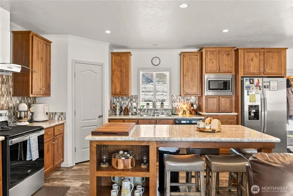 a kitchen with a stove a sink and a refrigerator