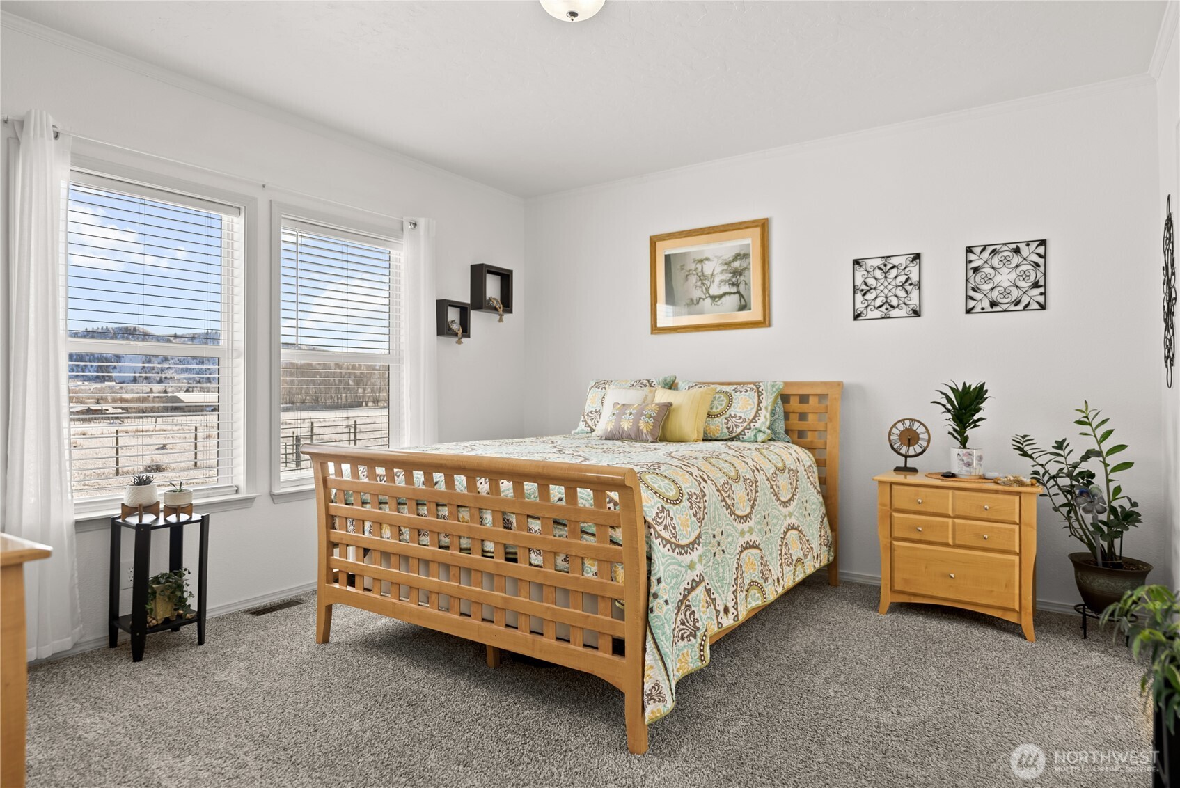 60 Alvarado Road Tonasket, WA 98855 - Photo 18 of 36 a large bed sitting in a bedroom next to a window and a couch