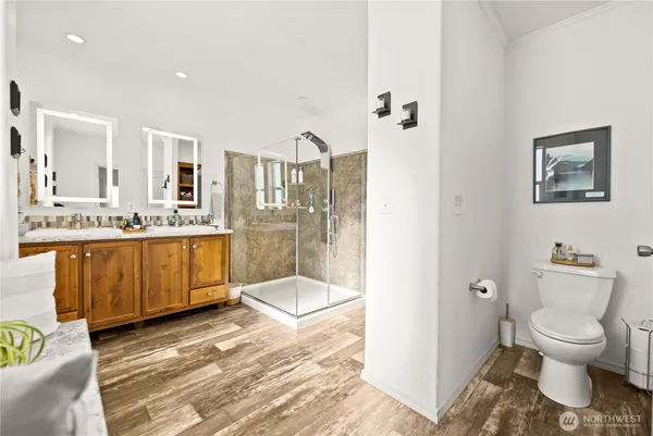 a bathroom with a granite countertop sink a toilet and a mirror