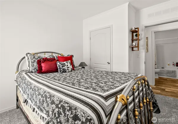 a bed sitting in a bedroom next to a window