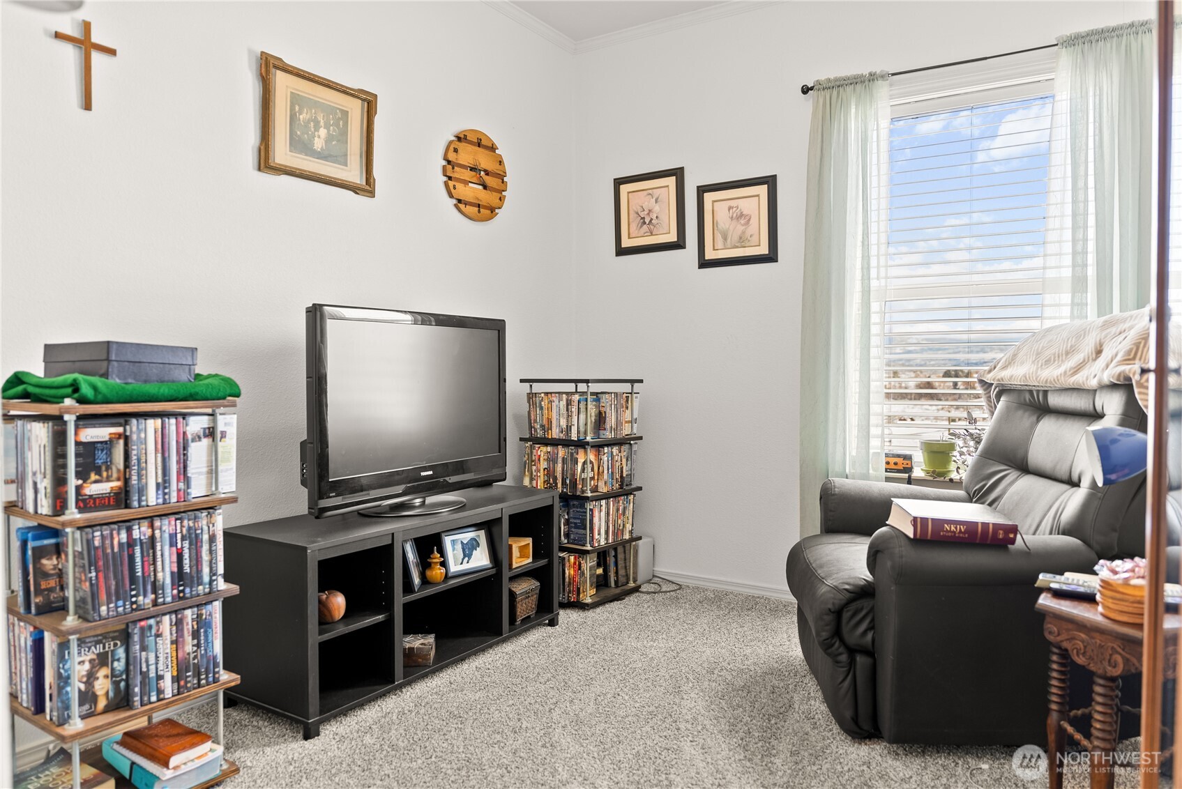 60 Alvarado Road Tonasket, WA 98855 - Photo 27 of 36 a living room with furniture a flat screen tv and a window