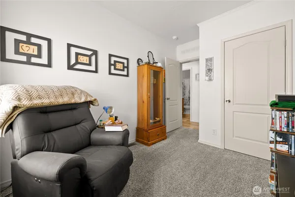 a living room with furniture and a walk in closet