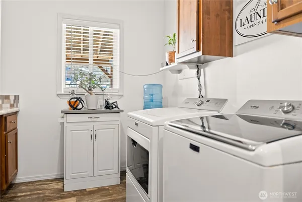 a kitchen with a sink and a stove next to a window