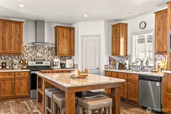 a kitchen with a stove a sink and a refrigerator