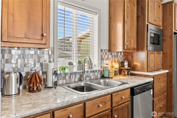 a kitchen with granite countertop a sink and a window