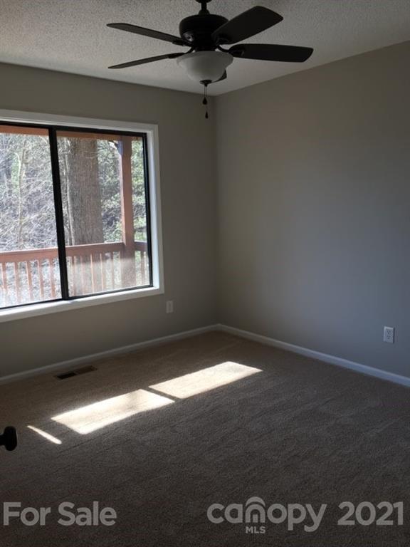 888 Rustic Heights Road Waynesville, NC 28785 - Photo 14 of 25 a view of an empty room with a window