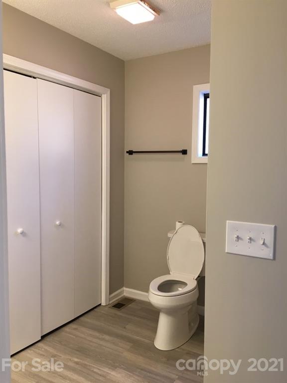 888 Rustic Heights Road Waynesville, NC 28785 - Photo 15 of 25 a white toilet sitting next to a bathroom sink
