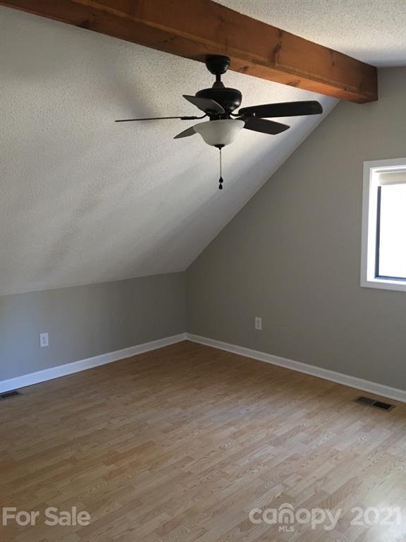 888 Rustic Heights Road Waynesville, NC 28785 - Photo 17 of 25 a view of an empty room with a window