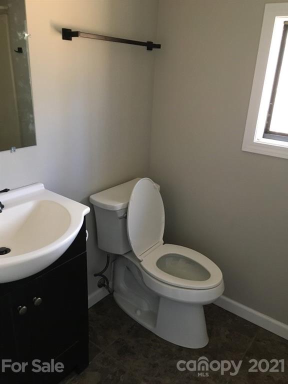 888 Rustic Heights Road Waynesville, NC 28785 - Photo 18 of 25 a bathroom with a toilet a sink and a window