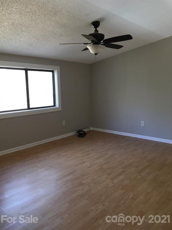 888 Rustic Heights Road Waynesville, NC 28785 - Photo 19 of 25 a view of a livingroom with a ceiling fan and window