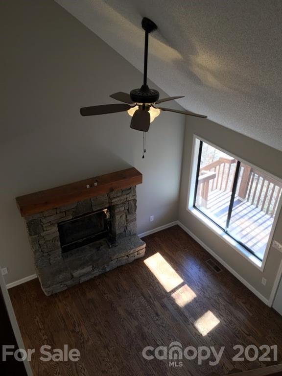 888 Rustic Heights Road Waynesville, NC 28785 - Photo 20 of 25 a living room with furniture and a fireplace