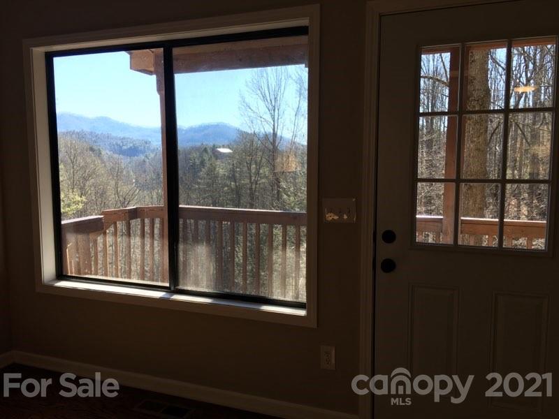 888 Rustic Heights Road Waynesville, NC 28785 - Photo 21 of 25 a view of an empty room with a window