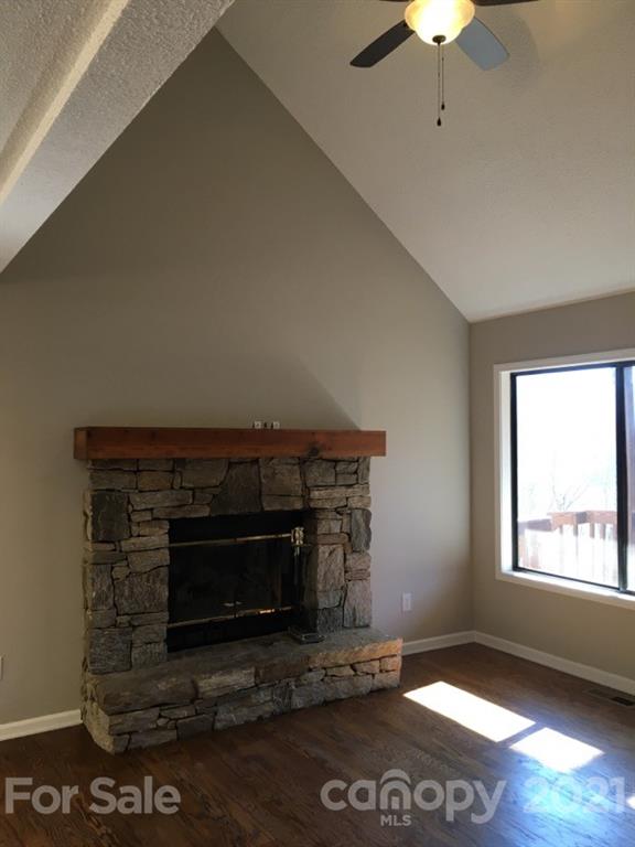 888 Rustic Heights Road Waynesville, NC 28785 - Photo 6 of 25 a living room with a fireplace