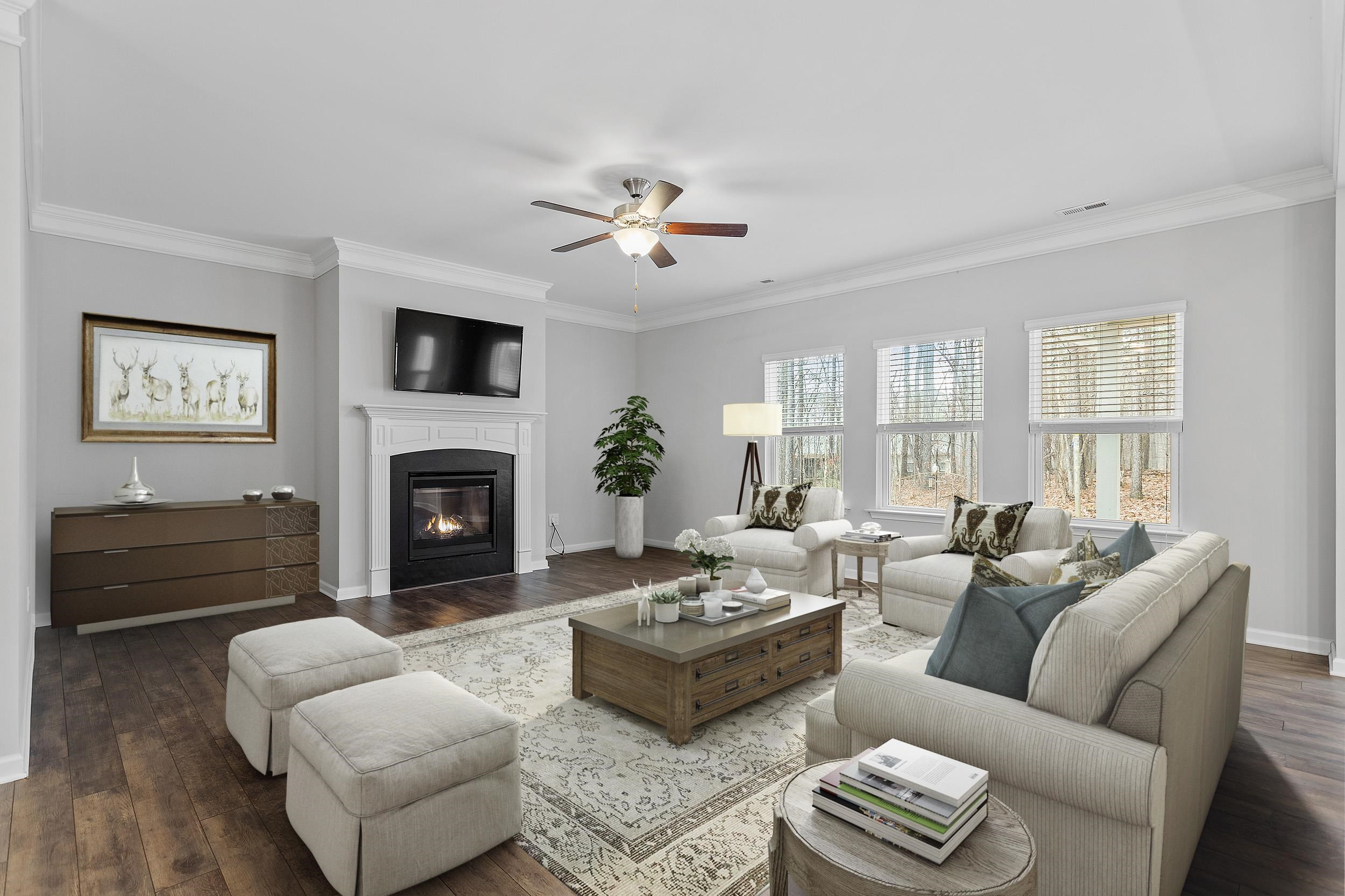 306 Springhill Lane Garner, NC 27529 - Photo 11 of 34 a living room with furniture a fireplace and a flat screen tv