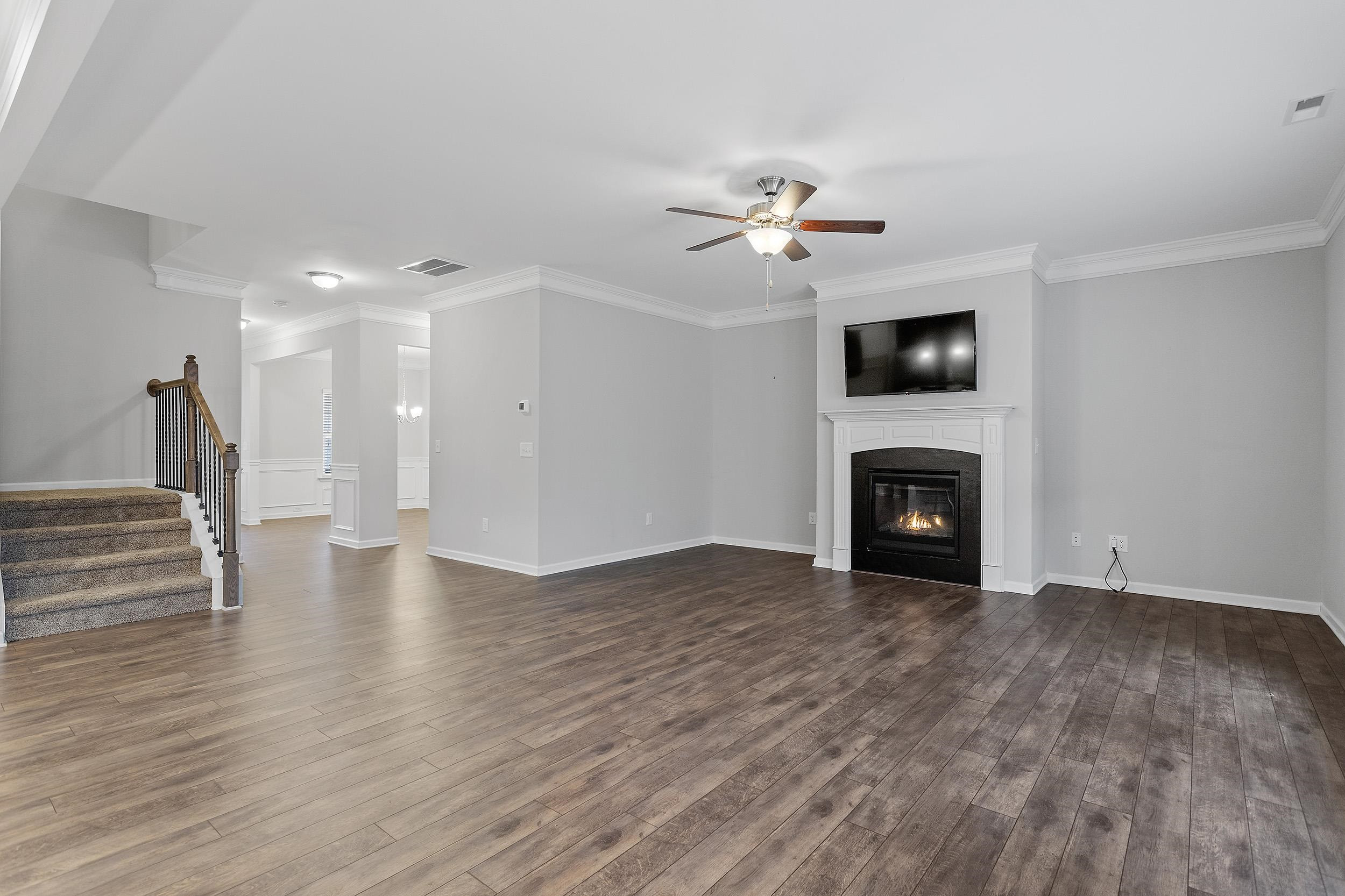 306 Springhill Lane Garner, NC 27529 - Photo 12 of 34 a view of empty room with wooden floor and fireplace
