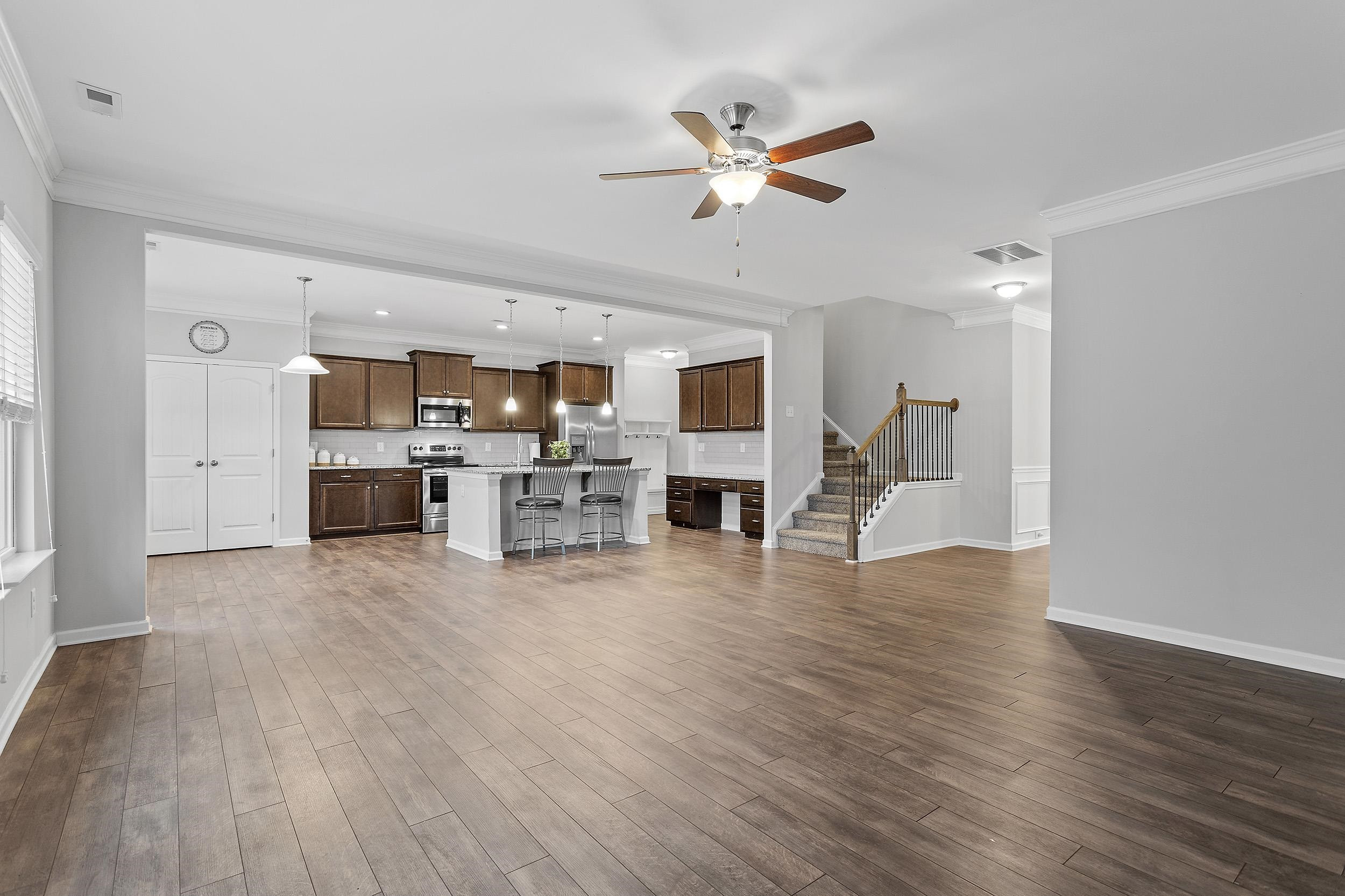 306 Springhill Lane Garner, NC 27529 - Photo 13 of 34 a view of kitchen and livingroom with furniture wooden floor