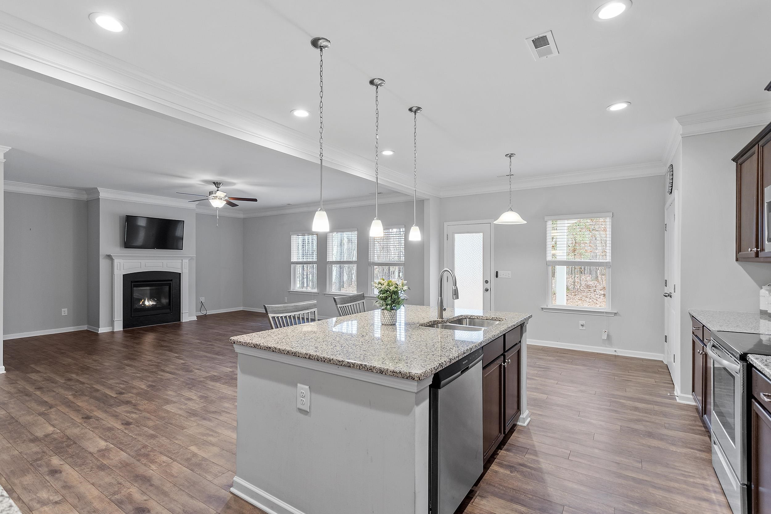 306 Springhill Lane Garner, NC 27529 - Photo 18 of 34 a kitchen with granite countertop a sink a counter top space and stainless steel appliances