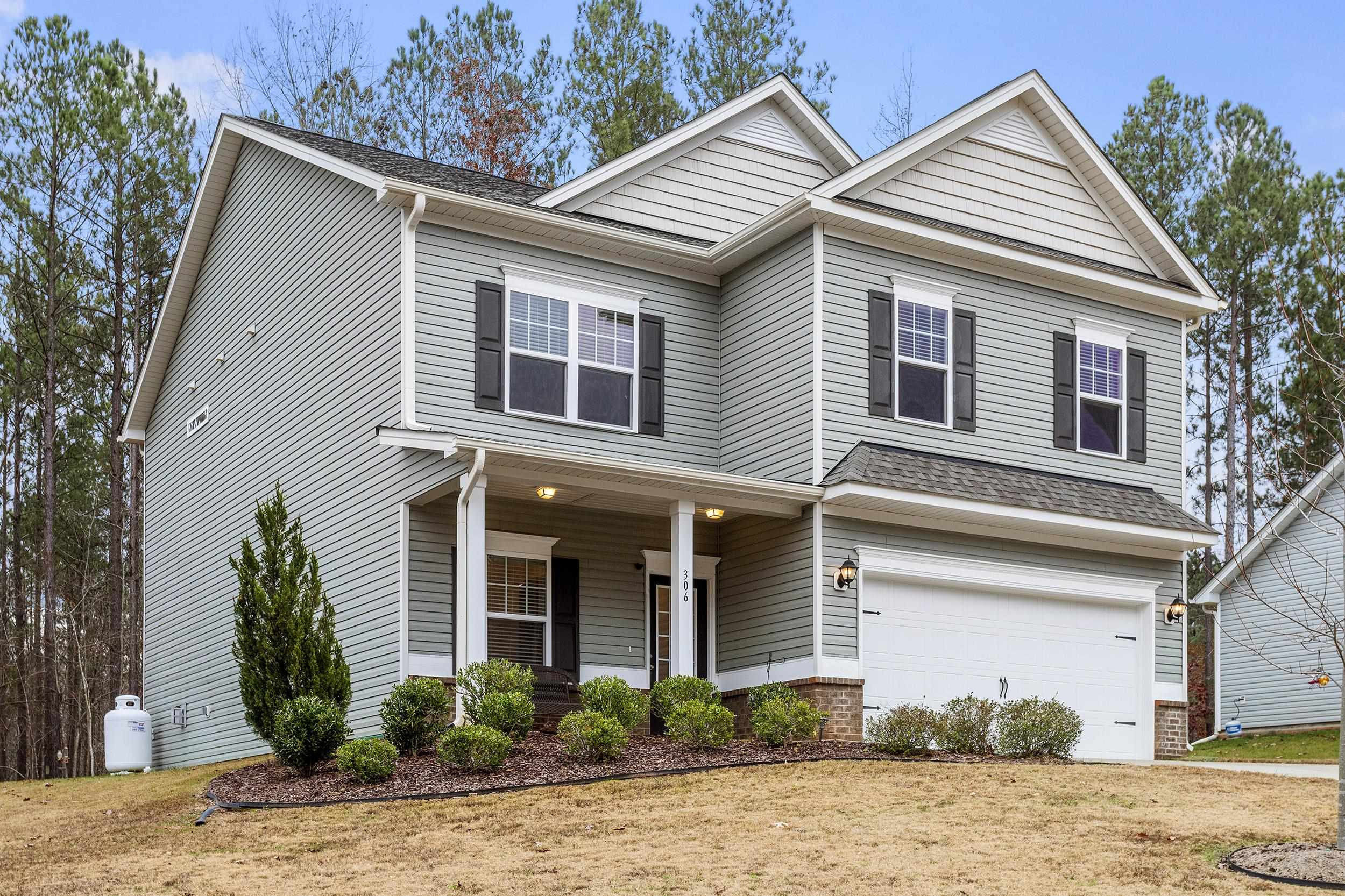 306 Springhill Lane Garner, NC 27529 - Photo 2 of 34 a view of a house with a yard plants and palm trees