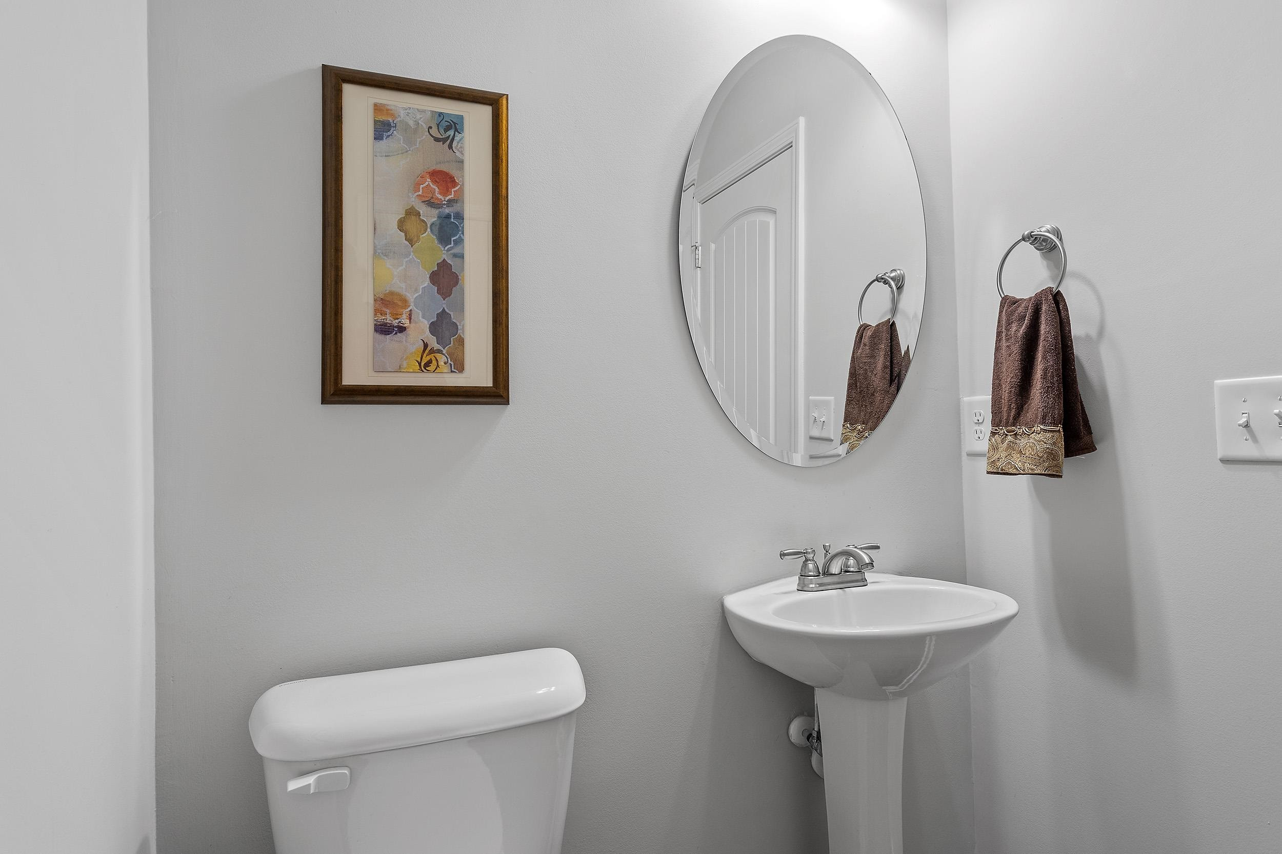 306 Springhill Lane Garner, NC 27529 - Photo 21 of 34 a bathroom with a toilet sink and mirror