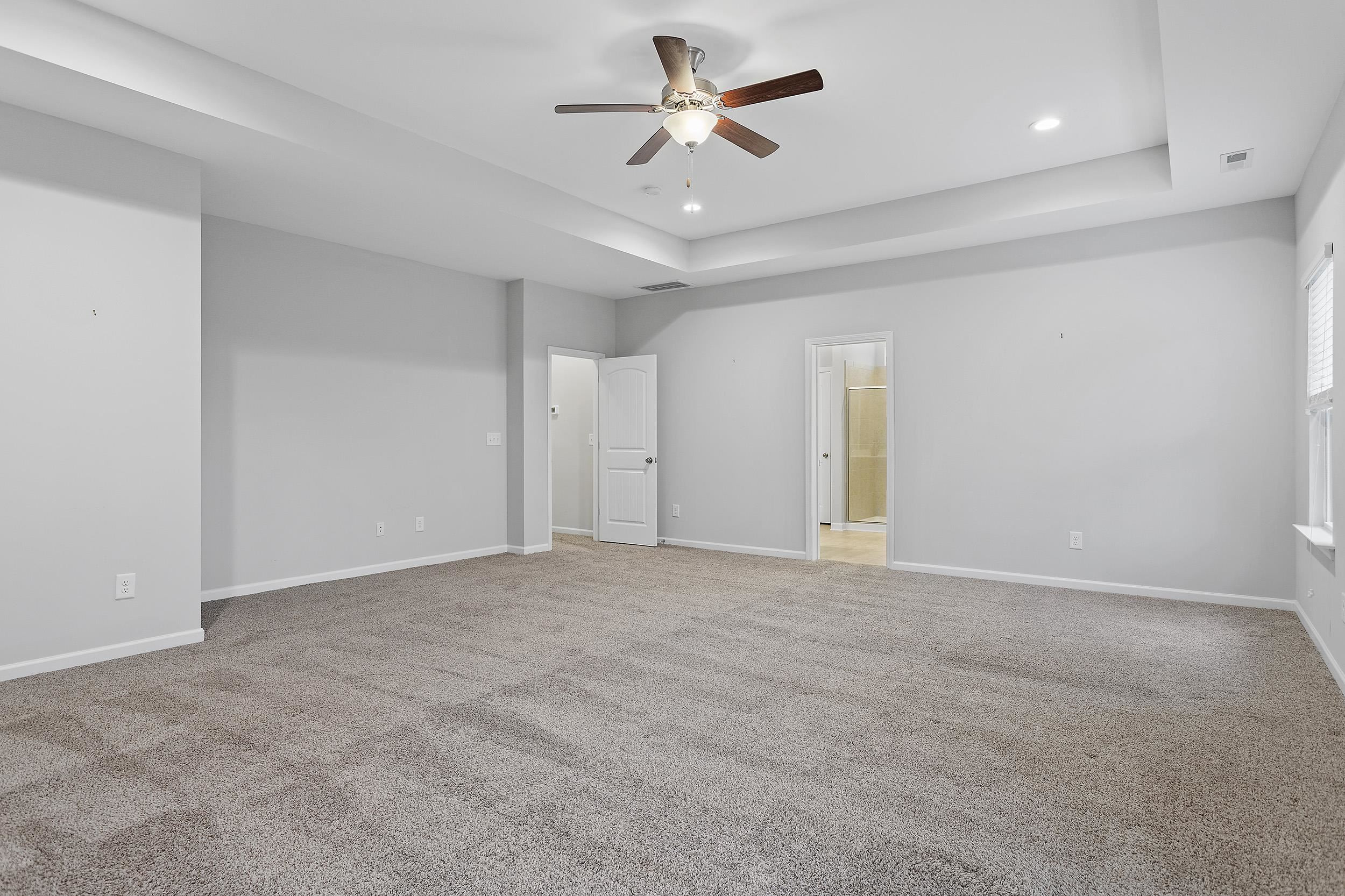 306 Springhill Lane Garner, NC 27529 - Photo 24 of 34 an empty room with fan and ceiling fan
